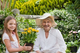 Grandmother with her granddaughter working in the garden