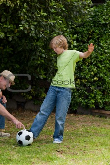 Grandfather and his grandson playing football
