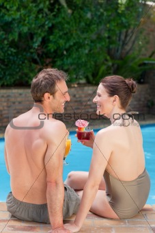 Happy couple drinking cocktails
