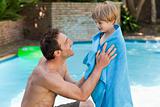 Father with his son beside the swimming pool