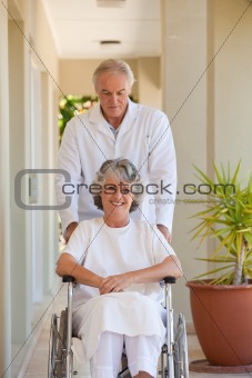Doctor with his patient in her wheelchair
