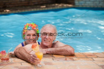 Happy mature couple in the swimming pool 
