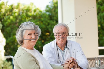 Senior doctor talking with his mature patient
