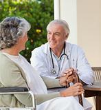 Senior doctor talking with his mature patient
