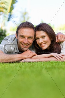 Couple lying down in the garden