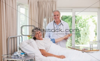 Senior doctor taking the blood pressure of his patient