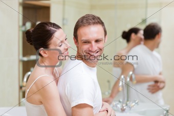Couple hugging in the bathroom