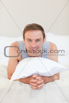 Man lying down on his bed