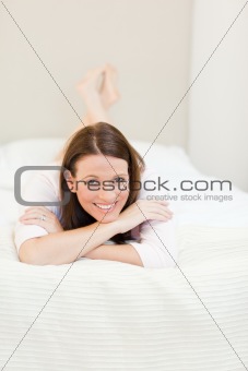 Pretty woman lying down on her bed