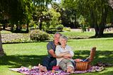 Elderly couple  picnicking in the garden 