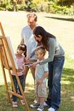 Family painting together in the park