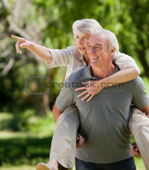 Man giving wife a piggyback