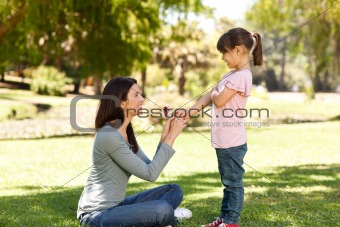 Joyful mother with her daughter in the park