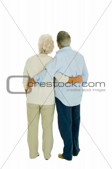 happy elderly couple embraced from behind