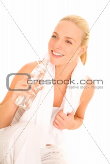 Woman with towel on her back drinking