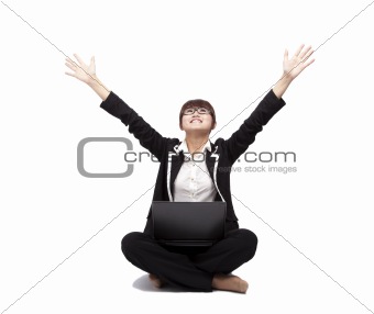 Happy Young woman sitting and using a laptop isolated on white background