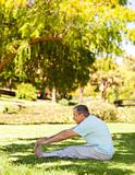 Mature man doing his streches in the park