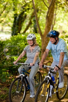 Senior couple mountain biking outside