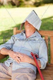 Senior man sleeping on the bench