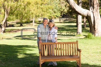 Portrait of a lovely couple behind the bench