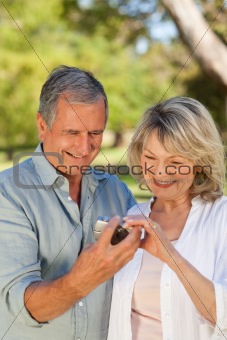 Mature couple looking at their camera