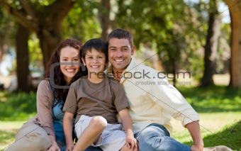 Joyful family sitting in the garden