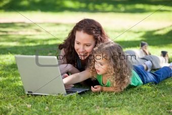 Mother and her daughter working on the laptop