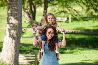 Mother giving daughter a piggyback