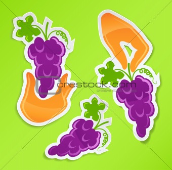 sticker with hand holding grapes