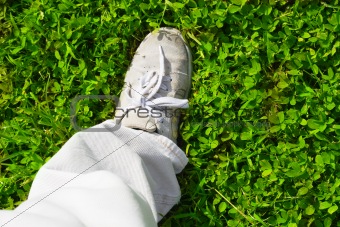 feet on a green grass 
