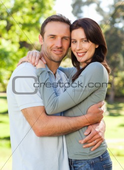 Radiant couple hugging in the park
