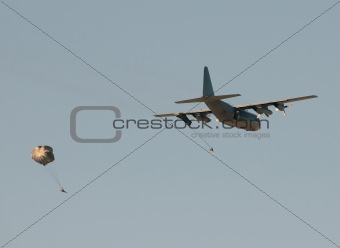 Transport airplane dropping soldiers