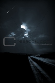 Single car travels on dark road