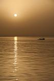 Small fishing boat at sunset