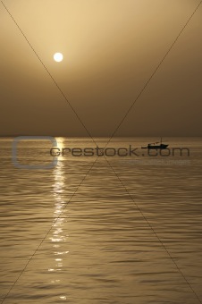 Small fishing boat at sunset
