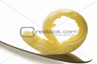 Butter on knife tip on white