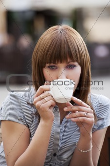 woman alone drinking a cup of tea