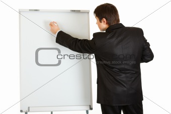 Modern businessman giving presentation using flipchart; place for text
