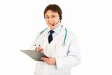 Smiling medical doctor with headset holding clipboard in hand
