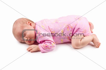 The sleeping newborn baby girl in pink isolated on a white background
