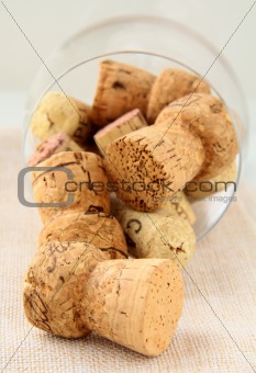 cork from bottles of wine in the glass on a pink napkin