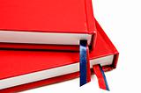 Close up of two red journals on white background