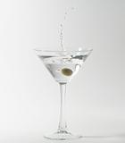 martini cocktail splashing into glass