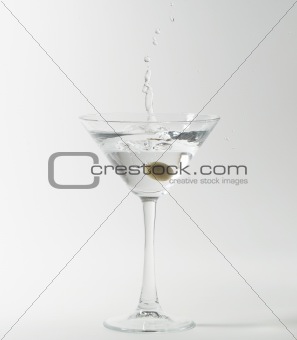 martini cocktail splashing into glass
