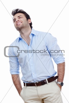 man in blue shirt and light trousers standing, smiling- isolated on white