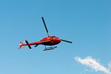 Red helicopter on the bright summer day