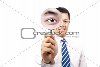 young businessman holding Magnifier and show his big eye