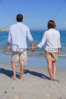 Enamored couple looking at the sea