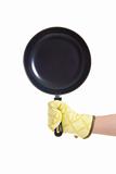 hand in gloves holding pan