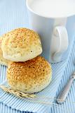 fresh rolls with sesame seeds and a glass of milk breakfast